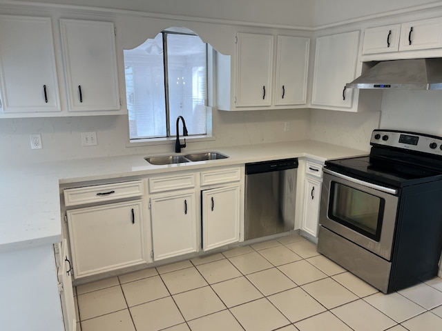 3714 Woodbriar Dr, Houston, TX 77068 - kitchen featuring appliances with stainless steel finishes, wall chimney range hood, a sink, and white cabinetry