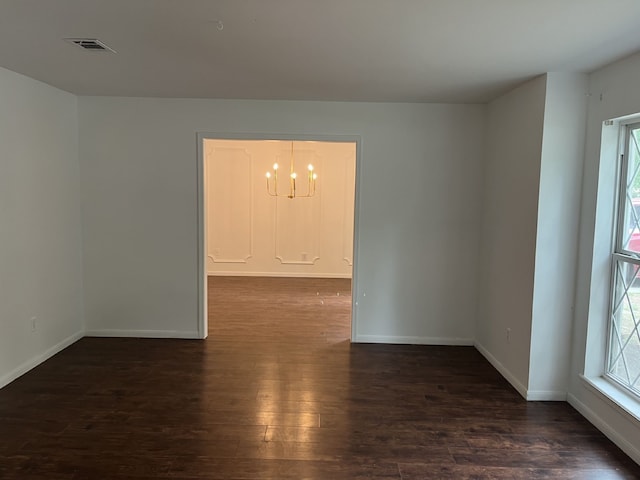 3714 Woodbriar Dr, Houston, TX 77068 - empty room with a chandelier, dark wood-style flooring, healthy amount of natural light, and baseboards