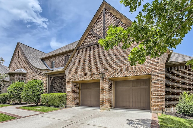 6 Freestone Stream Pl, Spring, TX 77389 - view of front facade with brick siding, concrete driveway, an attached garage, and roof with shingles