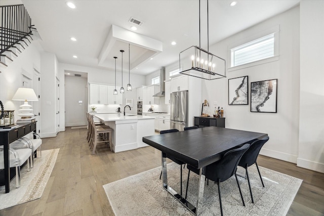 1026 Adele St, Houston, TX 77009 - dining room with plenty of natural light, light wood-style flooring, baseboards, and recessed lighting