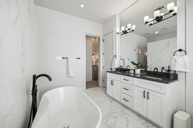 1026 Adele St, Houston, TX 77009 - full bath featuring marble look tile flooring, double vanity, a soaking tub, and recessed lighting