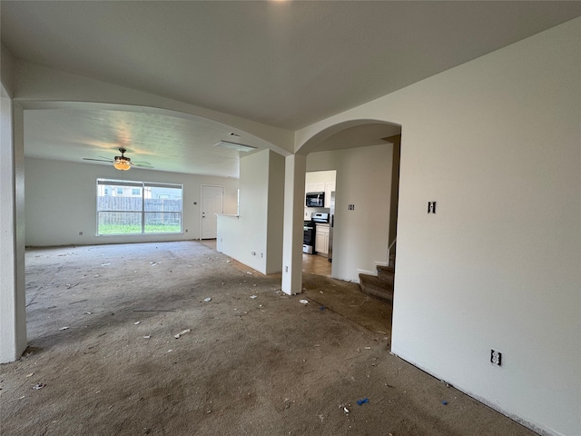 2606 Kiplands Ct, Houston, TX 77014 - unfurnished living room featuring carpet floors, stairs, a ceiling fan, and arched walkways