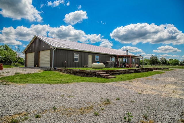 1850 Lcr 439, Groesbeck, TX 76667 - view of front of home featuring an outbuilding, metal roof, a garage, and board and batten siding