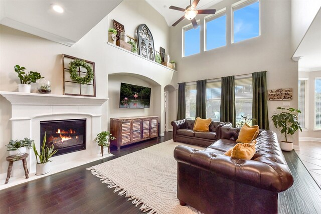 2610 Cedar Path Ln, Conroe, TX 77385 - living area with a fireplace with flush hearth, a ceiling fan, plenty of natural light, hardwood / wood-style flooring, and high vaulted ceiling