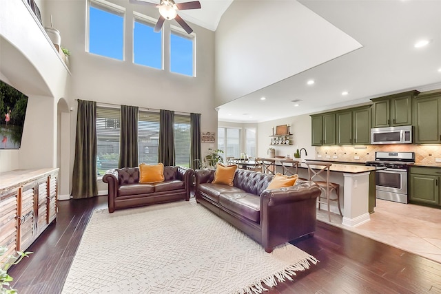 2610 Cedar Path Ln, Conroe, TX 77385 - living area with a ceiling fan, hardwood / wood-style flooring, healthy amount of natural light, a towering ceiling, and recessed lighting