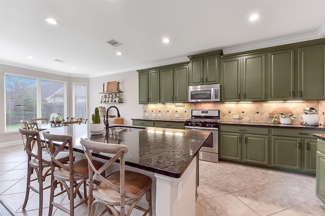 2610 Cedar Path Ln, Conroe, TX 77385 - kitchen featuring green cabinets, stainless steel appliances, a sink, crown molding, and decorative backsplash