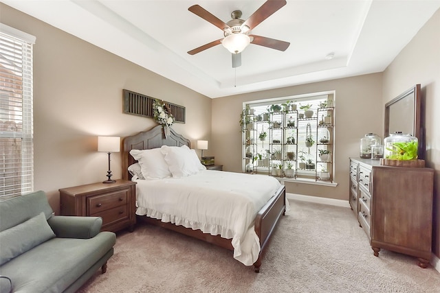 2610 Cedar Path Ln, Conroe, TX 77385 - bedroom with multiple windows, a raised ceiling, light carpet, and a ceiling fan