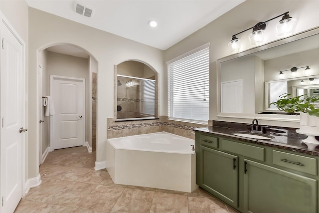 2610 Cedar Path Ln, Conroe, TX 77385 - full bathroom featuring a shower stall, a garden tub, vanity, and tile patterned floors