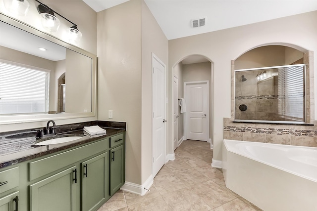2610 Cedar Path Ln, Conroe, TX 77385 - bathroom with vanity, tiled shower, a bath, baseboards, and tile patterned floors