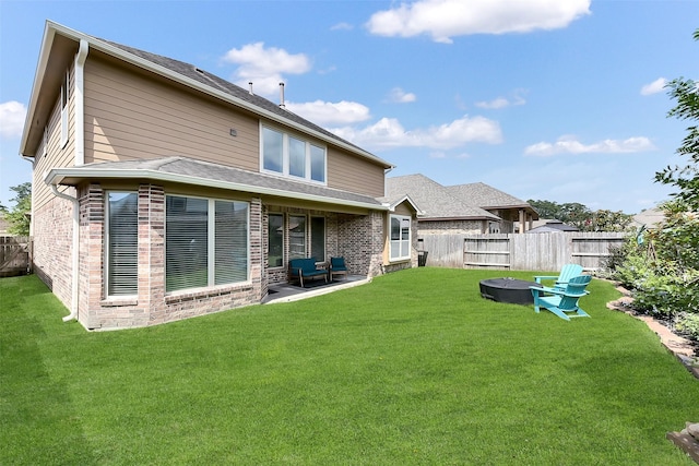 2610 Cedar Path Ln, Conroe, TX 77385 - rear view of property featuring an outdoor fire pit, a patio, and brick siding