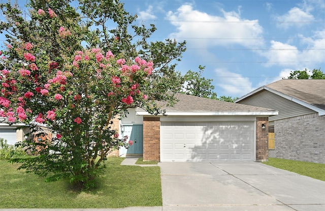9911 Berry Limb Dr, Houston, TX 77099 - view of front of property featuring brick siding, a garage, driveway, and a front yard