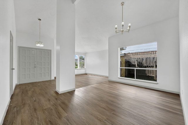9911 Berry Limb Dr, Houston, TX 77099 - unfurnished living room with a chandelier, wood finished floors, and baseboards