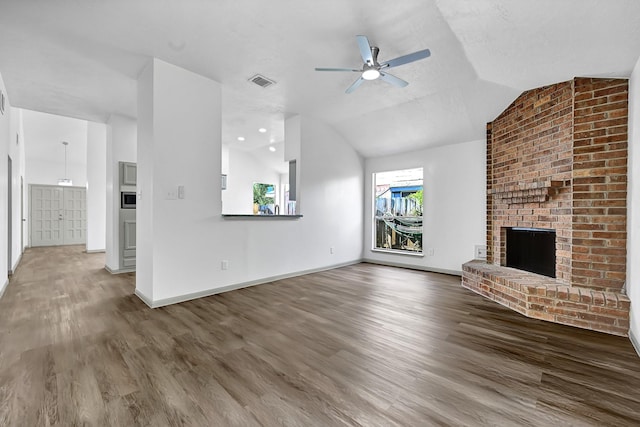 9911 Berry Limb Dr, Houston, TX 77099 - unfurnished living room with wood finished floors, a fireplace, a ceiling fan, lofted ceiling, and baseboards