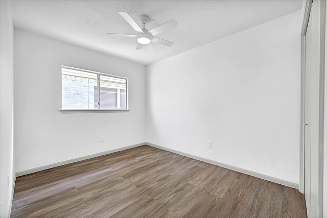 9911 Berry Limb Dr, Houston, TX 77099 - unfurnished room with wood finished floors, baseboards, and ceiling fan