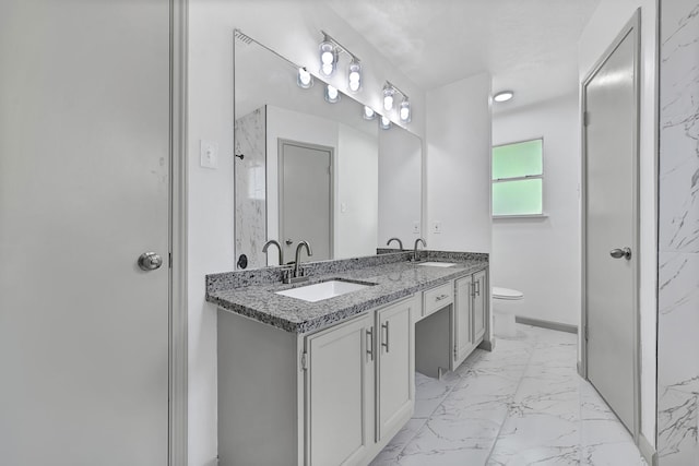 9911 Berry Limb Dr, Houston, TX 77099 - bathroom featuring marble look tiles, toilet, double vanity, baseboards, and a shower