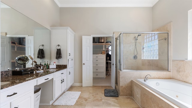 18725 Egret Oaks Ln, Webster, TX 77058 - full bathroom with double vanity, a spacious closet, a shower stall, a garden tub, and ornamental molding