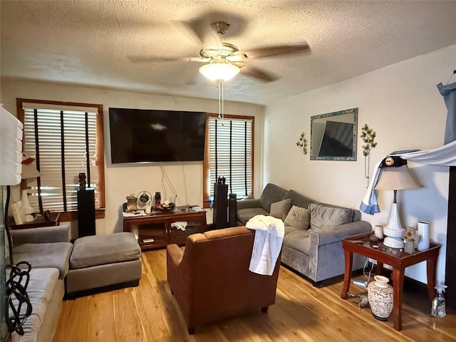 1509 Harry St, Victoria, TX 77901 - living room with a textured ceiling, ceiling fan, and light wood-style floors