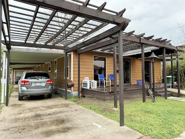 1509 Harry St, Victoria, TX 77901 - view of side of home featuring an attached carport, a lawn, concrete driveway, and a pergola