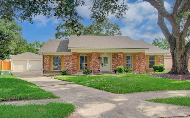15014 Carol Chase Cir, Houston, TX 77489 - view of front of home featuring a detached garage, brick siding, a shingled roof, and an outdoor structure