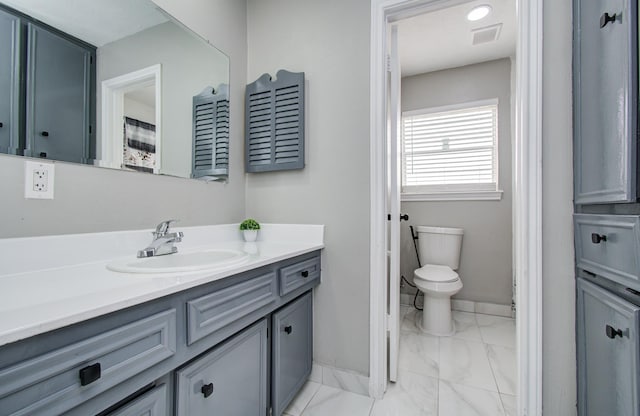 15014 Carol Chase Cir, Houston, TX 77489 - bathroom with marble finish floors, vanity, toilet, and baseboards