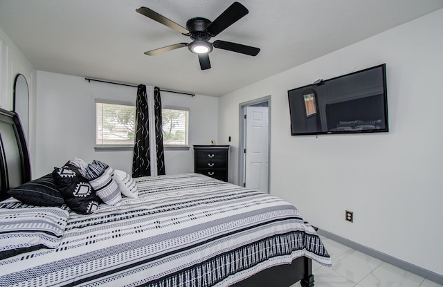 15014 Carol Chase Cir, Houston, TX 77489 - bedroom featuring light marble finish floors, a ceiling fan, and baseboards