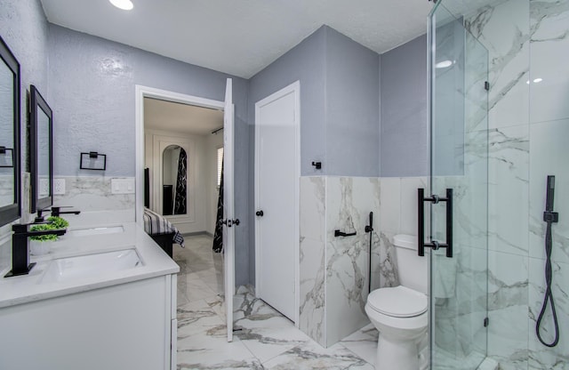 15014 Carol Chase Cir, Houston, TX 77489 - bathroom featuring marble tiled floors, a marble finish shower, double vanity, tile walls, and toilet