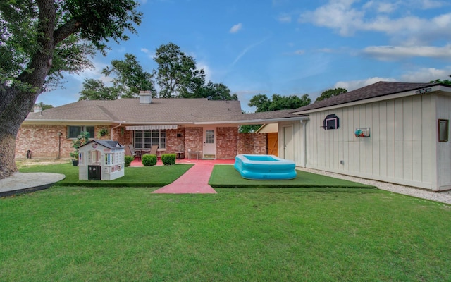 15014 Carol Chase Cir, Houston, TX 77489 - back of property featuring a yard, a chimney, brick siding, and a shingled roof