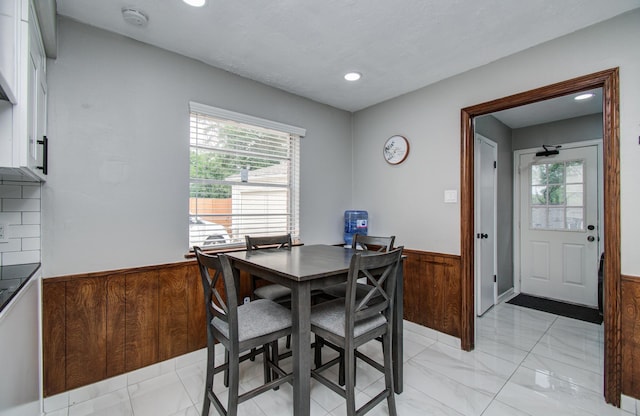 15014 Carol Chase Cir, Houston, TX 77489 - dining room with light marble finish floors, a wainscoted wall, recessed lighting, and wood walls