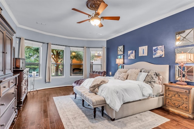5306 Lockwood Bend Ln, Sugar Land, TX 77479 - bedroom with multiple windows, dark wood-type flooring, ornamental molding, a ceiling fan, and baseboards