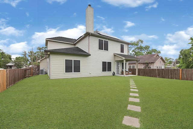 3518 Bain St, Houston, TX 77026 - rear view of property featuring roof mounted solar panels, a chimney, a patio area, central air condition unit, and roof with shingles