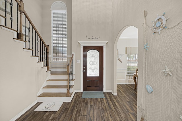 3518 Bain St, Houston, TX 77026 - foyer entrance with a high ceiling, wood finished floors, arched walkways, baseboards, and stairway