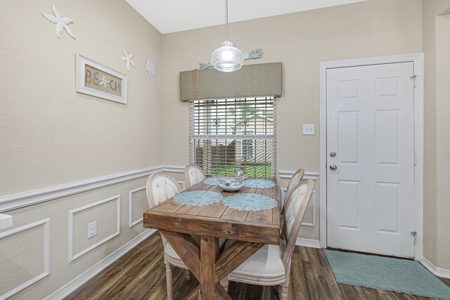 3518 Bain St, Houston, TX 77026 - dining space with dark wood-style flooring, a wainscoted wall, and a decorative wall