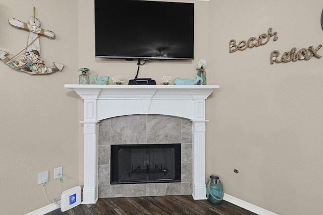 3518 Bain St, Houston, TX 77026 - detailed view of wood finished floors, baseboards, and a fireplace