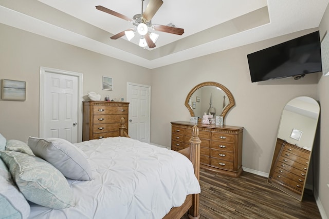 3518 Bain St, Houston, TX 77026 - bedroom with a raised ceiling, dark wood-type flooring, baseboards, and ceiling fan
