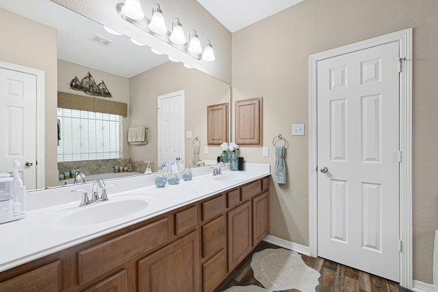3518 Bain St, Houston, TX 77026 - bathroom with double vanity, wood finished floors, and baseboards