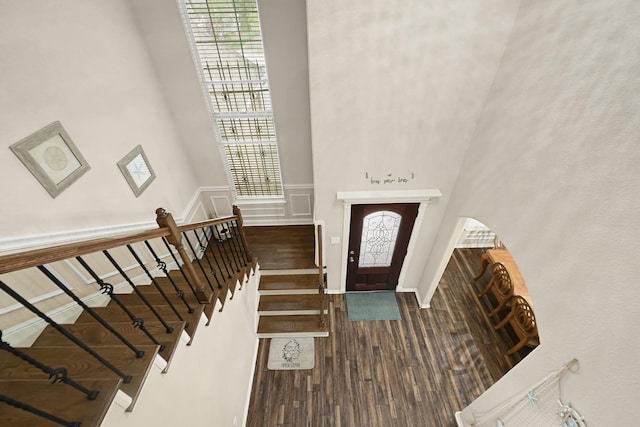 3518 Bain St, Houston, TX 77026 - entrance foyer with wood finished floors, a decorative wall, stairs, and a wainscoted wall