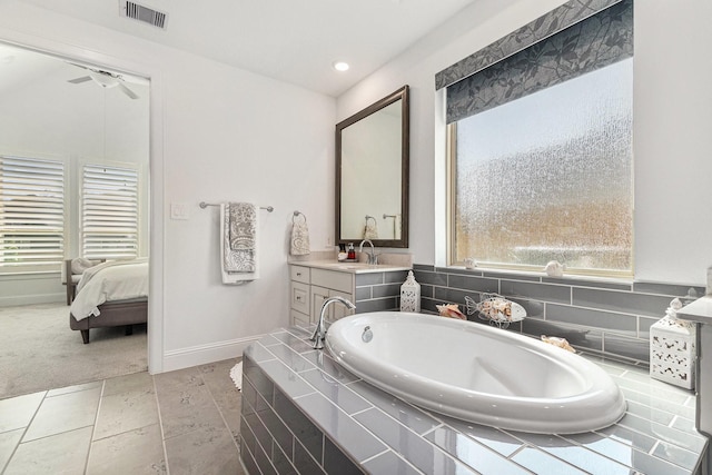 1059 Lakemont Bend Ln, Pinehurst, TX 77362 - full bathroom featuring a garden tub, vanity, baseboards, a ceiling fan, and ensuite bathroom