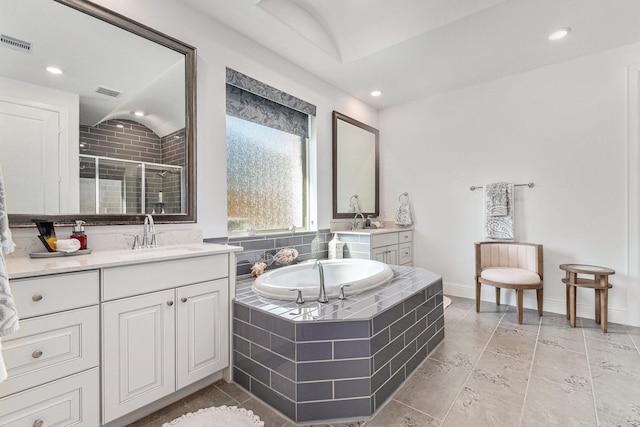 1059 Lakemont Bend Ln, Pinehurst, TX 77362 - bathroom featuring a stall shower, two vanities, a garden tub, recessed lighting, and baseboards