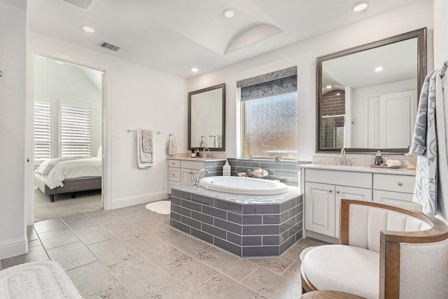 1059 Lakemont Bend Ln, Pinehurst, TX 77362 - full bath featuring healthy amount of natural light, a garden tub, two vanities, baseboards, and recessed lighting