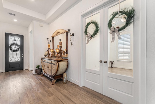 1059 Lakemont Bend Ln, Pinehurst, TX 77362 - entrance foyer featuring french doors, wood finished floors, recessed lighting, and baseboards