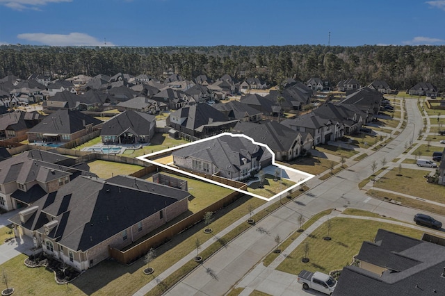 1059 Lakemont Bend Ln, Pinehurst, TX 77362 - aerial perspective of suburban area featuring property parcel outlined and a heavily wooded area