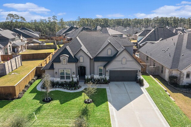 1059 Lakemont Bend Ln, Pinehurst, TX 77362 - french country inspired facade with stucco siding, a residential view, roof with shingles, concrete driveway, and an attached garage