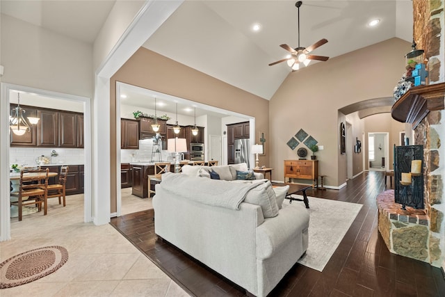 15019 Turquoise Mist Dr, Cypress, TX 77433 - living room with arched walkways, ceiling fan, high vaulted ceiling, dark wood-style floors, and recessed lighting