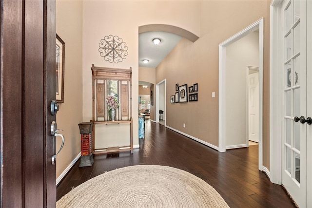 15019 Turquoise Mist Dr, Cypress, TX 77433 - entrance foyer featuring dark wood finished floors, arched walkways, and baseboards