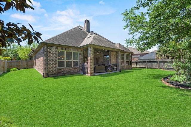 15019 Turquoise Mist Dr, Cypress, TX 77433 - rear view of property with brick siding, roof with shingles, a patio, and a chimney