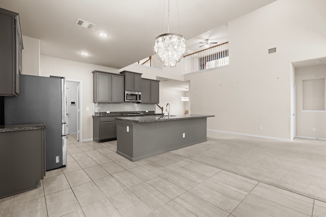 7603 Millstone Trail Ln, Richmond, TX 77469 - kitchen with stainless steel appliances, a sink, light colored carpet, ceiling fan, and light tile patterned flooring