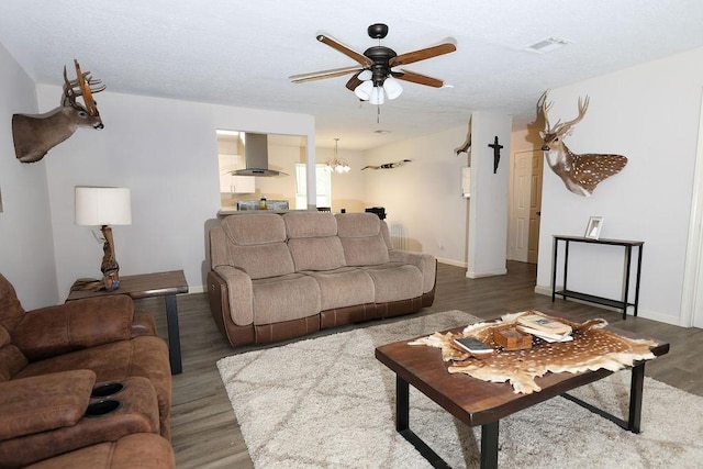 13911 W Richmond St, Needville, TX 77461 - living room featuring wood finished floors, a ceiling fan, baseboards, and a chandelier