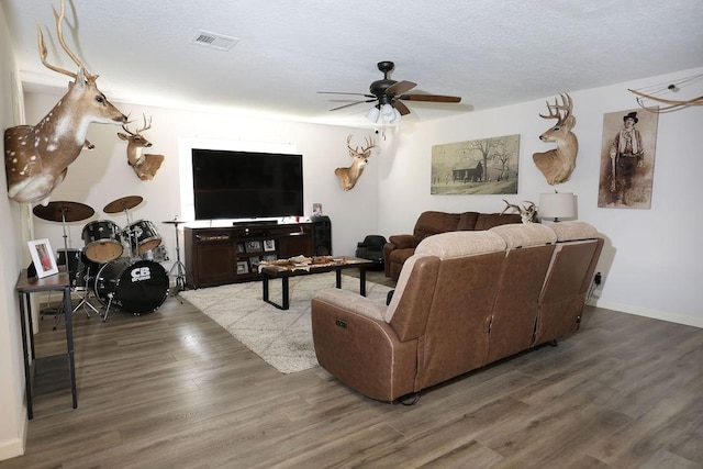 13911 W Richmond St, Needville, TX 77461 - living area with a ceiling fan, wood finished floors, baseboards, and a textured ceiling