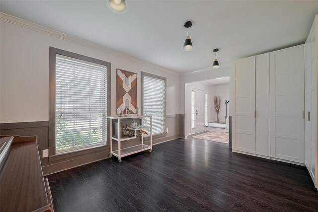 18206 Lake Bend Dr, Houston, TX 77084 - spare room featuring dark wood-type flooring, ornamental molding, and wainscoting