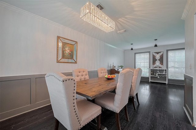 18206 Lake Bend Dr, Houston, TX 77084 - dining space with a chandelier, a decorative wall, dark wood-type flooring, crown molding, and a wainscoted wall